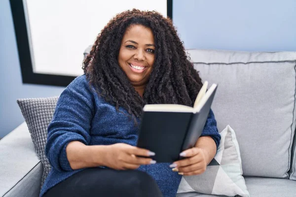 African American Woman Reading Book Sitting Sofa Home — 图库照片
