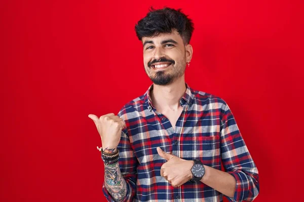 Jonge Spaanse Man Met Baard Die Rode Achtergrond Naar Achteren — Stockfoto