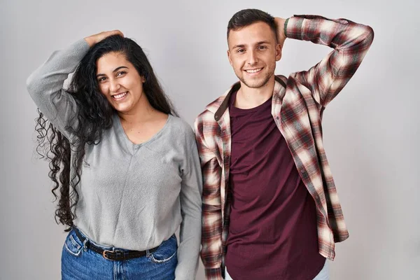 Young Hispanic Couple Standing White Background Smiling Confident Touching Hair — Stock Photo, Image