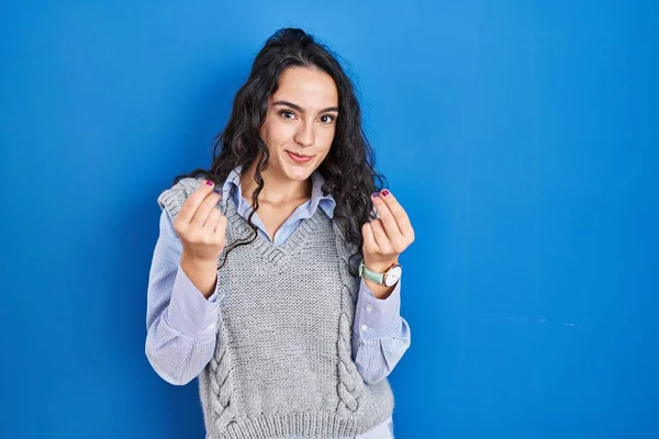 Young Brunette Woman Standing Blue Background Doing Money Gesture Hands — Stock Photo, Image