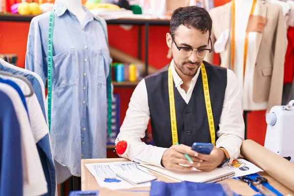 Young Hispanic Man Tailor Using Smartphone Atelier — Stock Fotó