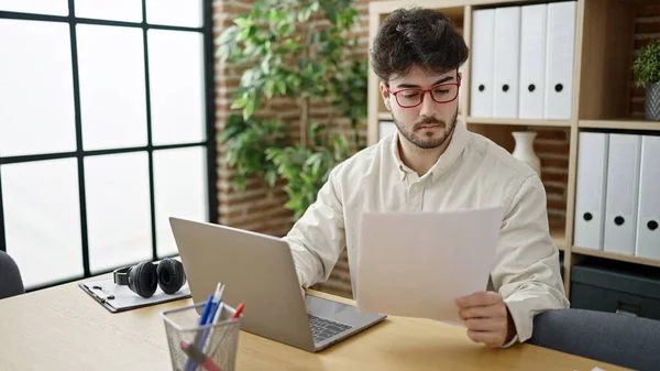 Young Hispanic Man Business Worker Using Laptop Reading Document Office — Zdjęcie stockowe