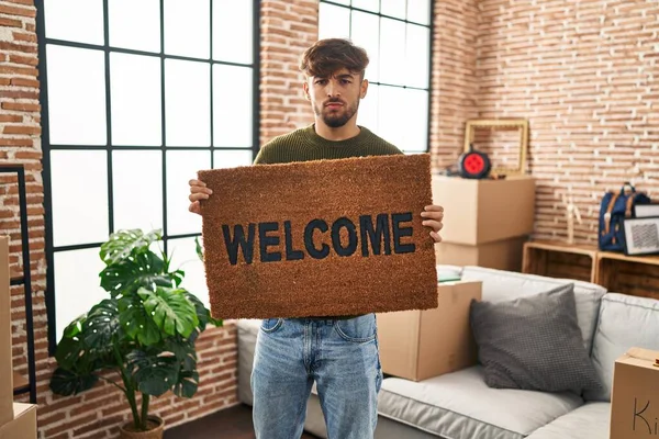 Arab Man Beard Holding Welcome Doormat Skeptic Nervous Frowning Upset — Stockfoto