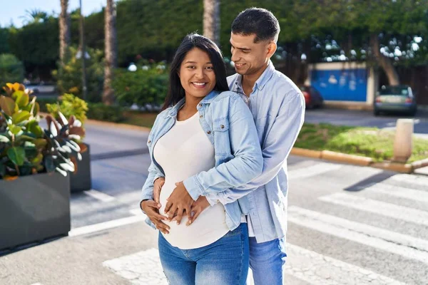 Young Latin Couple Expecting Baby Hugging Each Other Standing Street — Stockfoto