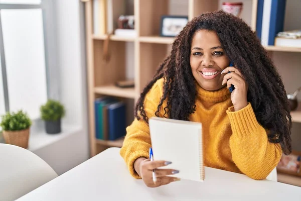 African American Woman Talking Smartphone Reading Notebook Home — Stockfoto