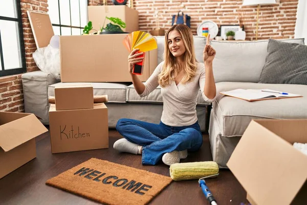 Young Blonde Woman Choosing Paint Color New Home Smiling Idea — Stock Photo, Image