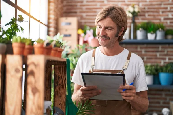 Young Blond Man Florist Smiling Confident Reading Document Flower Shop — Stock Photo, Image