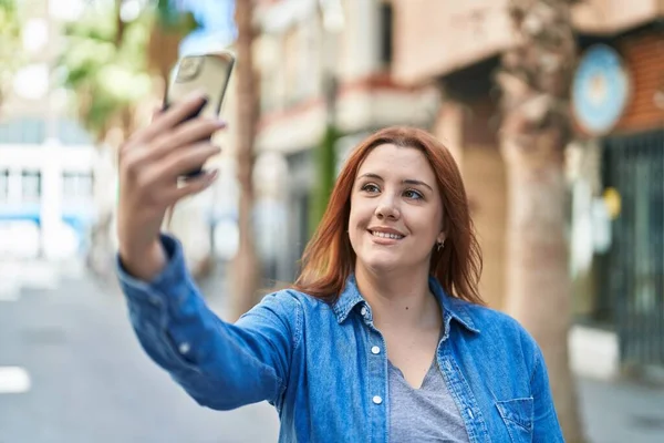 stock image Young beautiful plus size woman smiling confident making selfie by the smartphone at street