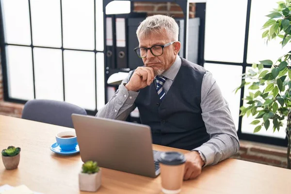 stock image Middle age grey-haired man business worker using laptop with doubt expression at office