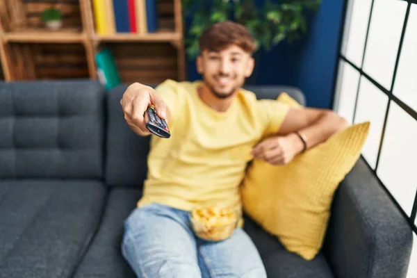 Ung Arabisk Man Äter Chips Potatis Titta Film Hemma — Stockfoto