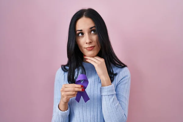 Hispanic Woman Holding Purple Ribbon Awareness Serious Face Thinking Question — Stock Photo, Image