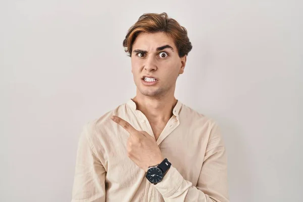 Young Man Standing Isolated Background Pointing Aside Worried Nervous Forefinger — Foto Stock