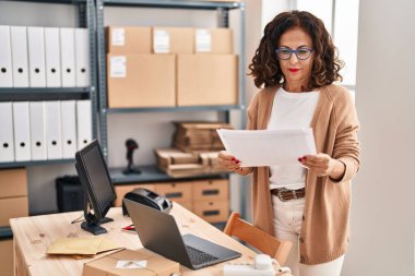 Middle age hispanic woman working at ecommerce