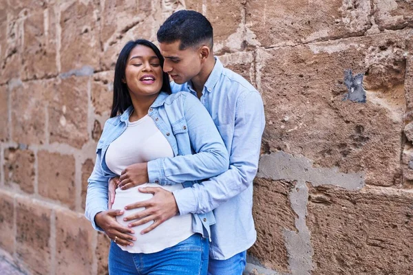 Young Latin Couple Expecting Baby Touching Belly Street — Stockfoto