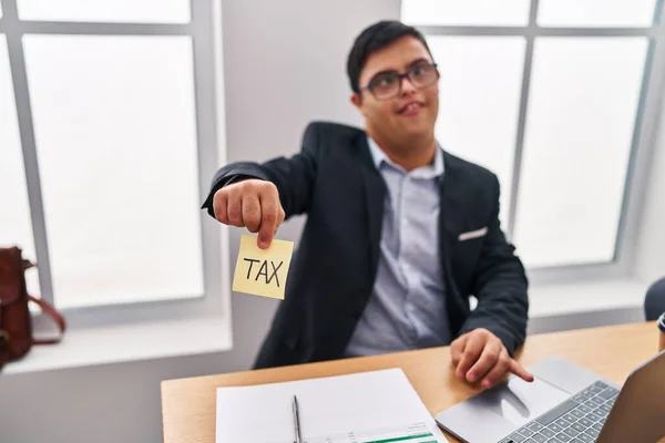Down syndrome man business worker holding tax reminder paper at office