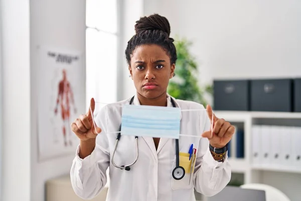 Young African American Braids Wearing Doctor Uniform Holding Safety Mask — Stockfoto