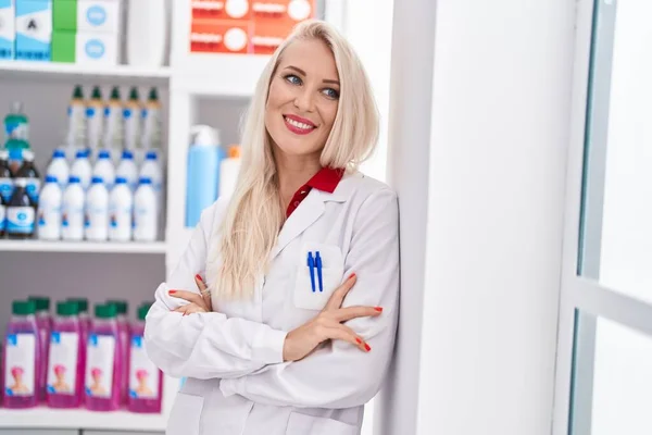 Young Blonde Woman Pharmacist Smiling Confident Standing Arms Crossed Gesture — Stock Photo, Image