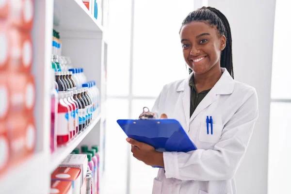 African American Woman Pharmacist Smiling Confident Writing Document Pharmacy — Stockfoto