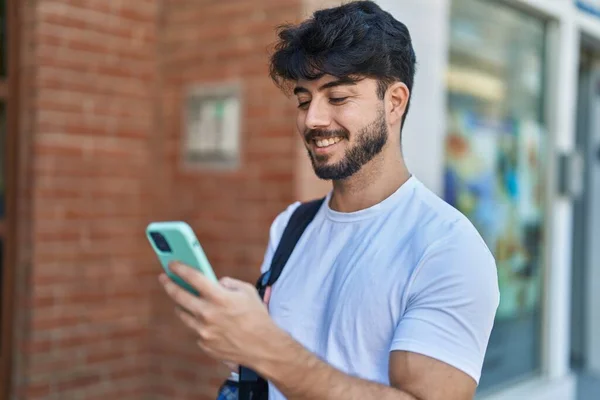 Young Hispanic Man Wearing Backpack Using Smartphone Street — ストック写真
