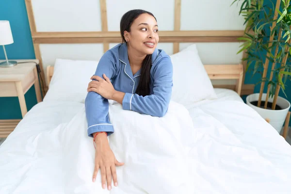 stock image Young arab woman smiling confident sitting on bed at bedroom