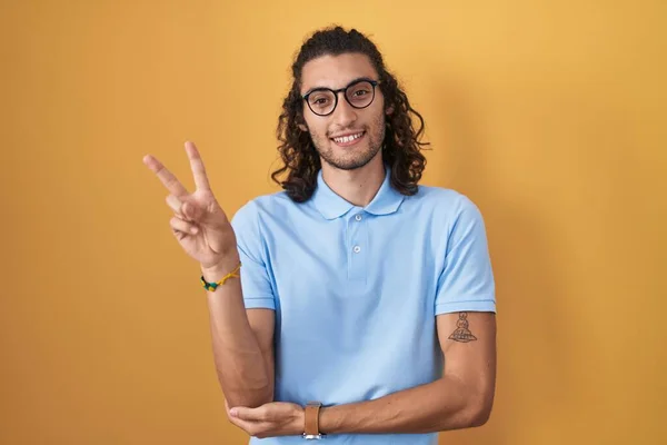 Young Hispanic Man Standing Yellow Background Smiling Happy Face Winking — Stok fotoğraf