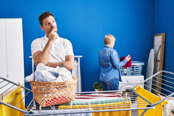 Hispanic Mother Son Hanging Clothes Clothesline Serious Face Thinking Question — Stockfoto