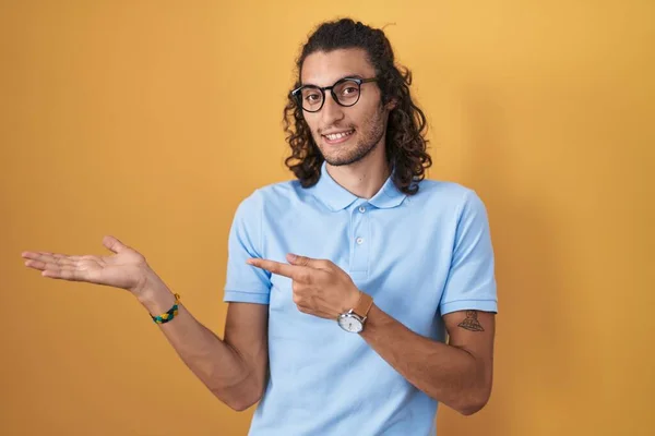 Young Hispanic Man Standing Yellow Background Amazed Smiling Camera While — Stok fotoğraf
