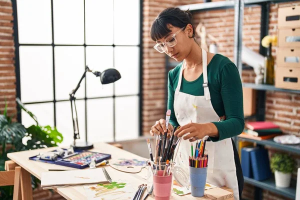 Young Beautiful Hispanic Woman Artist Holding Paintbrushes Art Studio — 스톡 사진