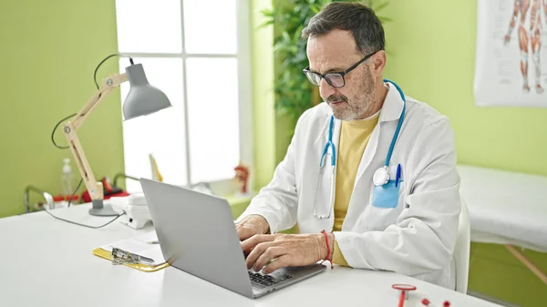 Middle Age Man Doctor Using Laptop Working Clinic — Photo