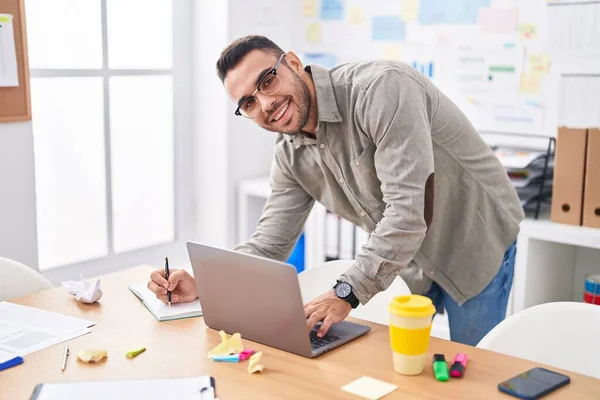 Young Hispanic Man Business Worker Using Laptop Writing Notebook Office — Stockfoto