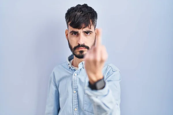 Young Hispanic Man Beard Standing Blue Background Showing Middle Finger — Stok fotoğraf