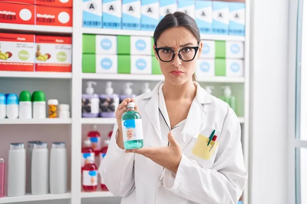 Brunette Woman Working Pharmacy Drugstore Holding Cough Syrup Skeptic Nervous — ストック写真