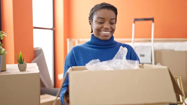 African American Woman Smiling Confident Holding Package New Home — Stock Photo, Image