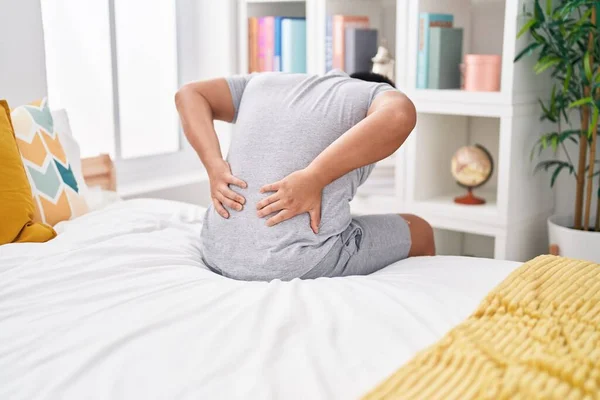 Young Chinese Man Suffering Back Injury Sitting Bed Bedroom — Stock Photo, Image