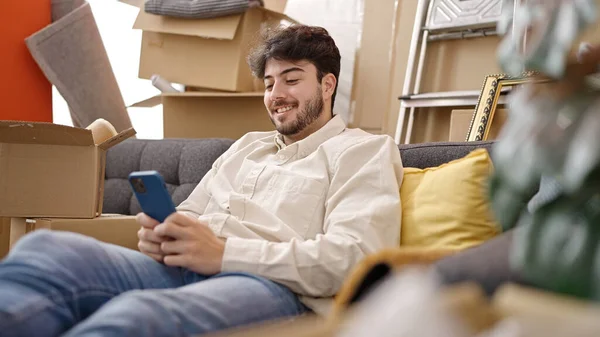 Jeune Homme Hispanique Utilisant Smartphone Assis Sur Canapé Nouvelle Maison — Photo