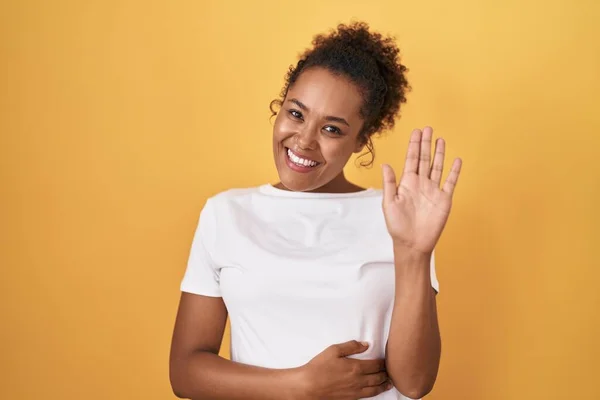 Young Hispanic Woman Curly Hair Standing Yellow Background Waiving Saying — Stock Photo, Image