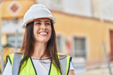 Young beautiful hispanic woman architect smiling confident standing at street