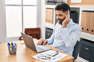 Young hispanic man call center agent having video call at office