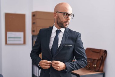 Young bald man business worker wearing jacket at office