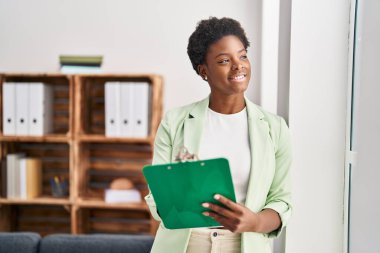 African american woman psychologist holding clipboard at psychology center