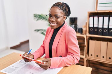 Ofiste dokunmatik ped kullanan Afrikalı Amerikalı iş kadını.