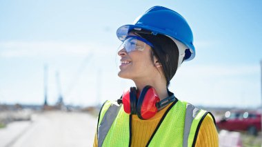 Young beautiful hispanic woman architect smiling confident standing at street