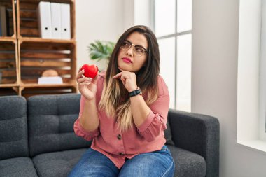 Genç İspanyol kadın danışmanlık ofisinde çift terapisi üzerinde çalışıyor. Ciddi yüz ifadesi var. Çene üstüne el ele soru sormayı düşünüyor. 