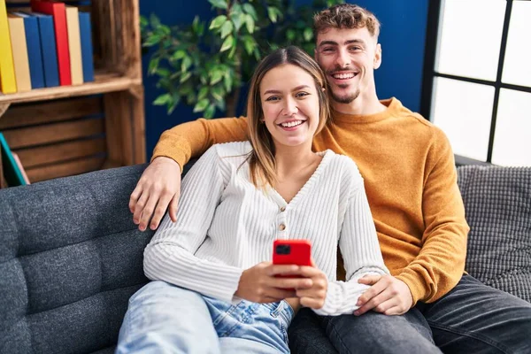 Genç Adam Kadın Çift Akıllı Telefon Kullanarak Evdeki Kanepede Oturuyorlar — Stok fotoğraf