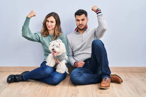 Young Hispanic Couple Sitting Floor Dog Strong Person Showing Arm — Stock Photo, Image