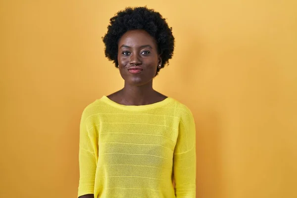 African Young Woman Standing Yellow Studio Puffing Cheeks Funny Face — Stock Photo, Image