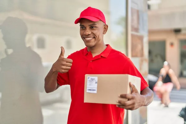Young Latin Man Delivery Worker Holding Package Doig Gesture Finger — Stok fotoğraf