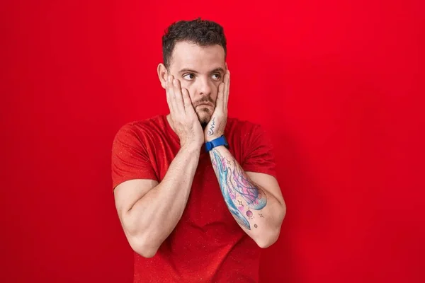 Young Hispanic Man Standing Red Background Tired Hands Covering Face — Stockfoto