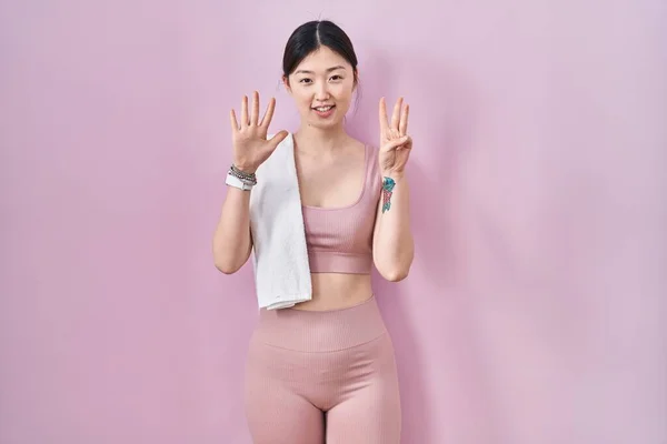 Chinese Young Woman Wearing Sportswear Towel Showing Pointing Fingers Number — Stock Photo, Image
