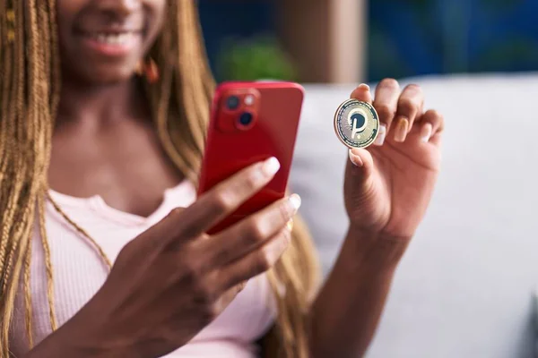African American Woman Holding Polkadot Crypto Currency Using Smartphone Home — Stock Photo, Image
